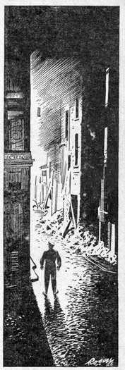 A man standing at the head of a street with ruined buildings.