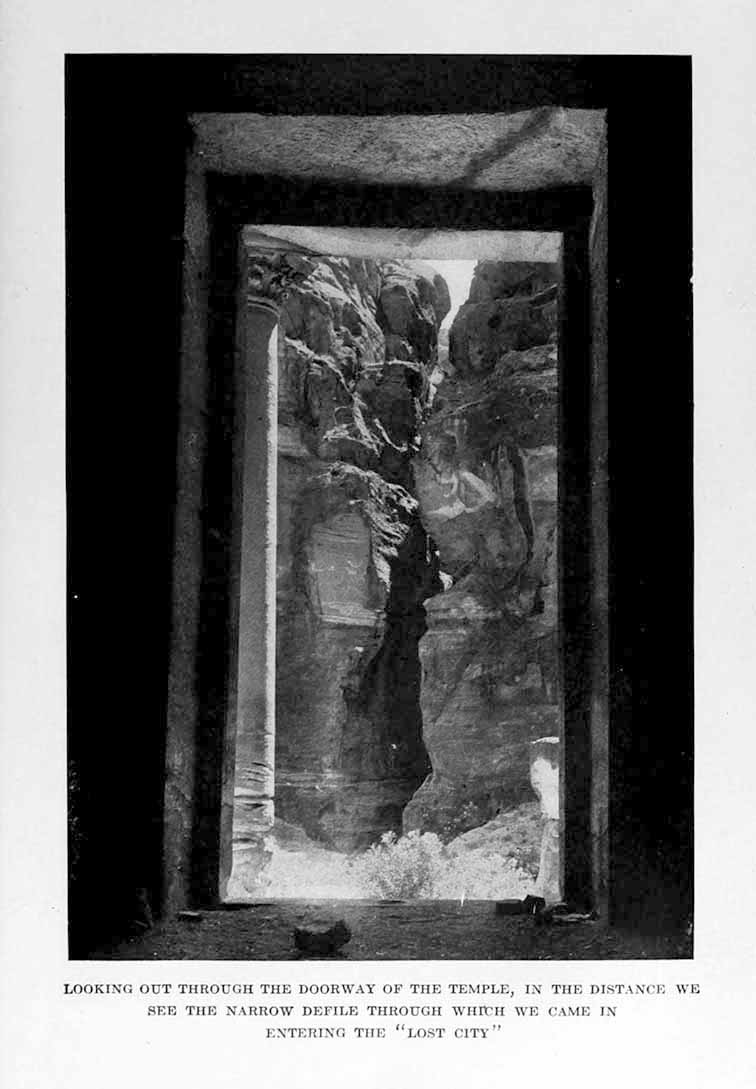 Photograph: LOOKING OUT THROUGH THE DOORWAY OF THE TEMPLE,
IN THE DISTANCE WE SEE THE NARROW DEFILE THROUGH WHICH WE CAME IN ENTERING THE “LOST CITY”